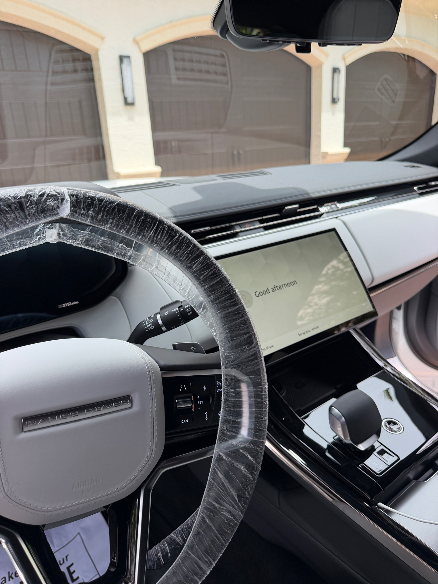 Detailed Range Rover interior with white leather and protected steering wheel
