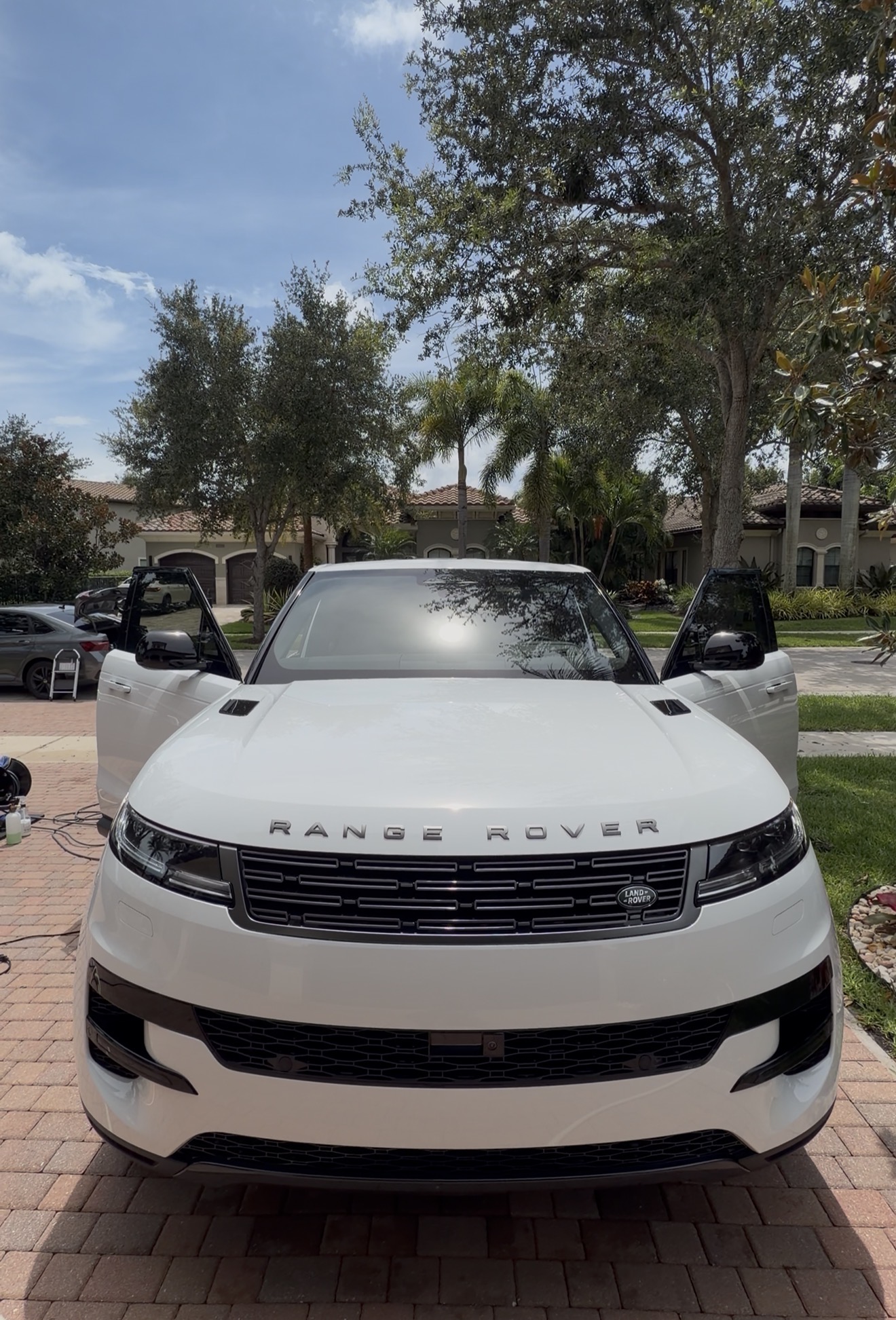 Detailed white Range Rover Sport with mirror-finish paint in a South Florida driveway