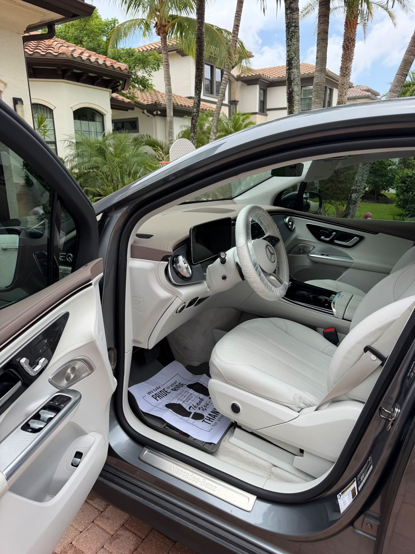 Freshly detailed Mercedes-Benz EQS interior with beige leather and protected steering wheel